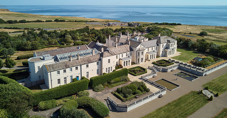 Aerial shot of Seaham Hall hotel and grounds with North Sea in background